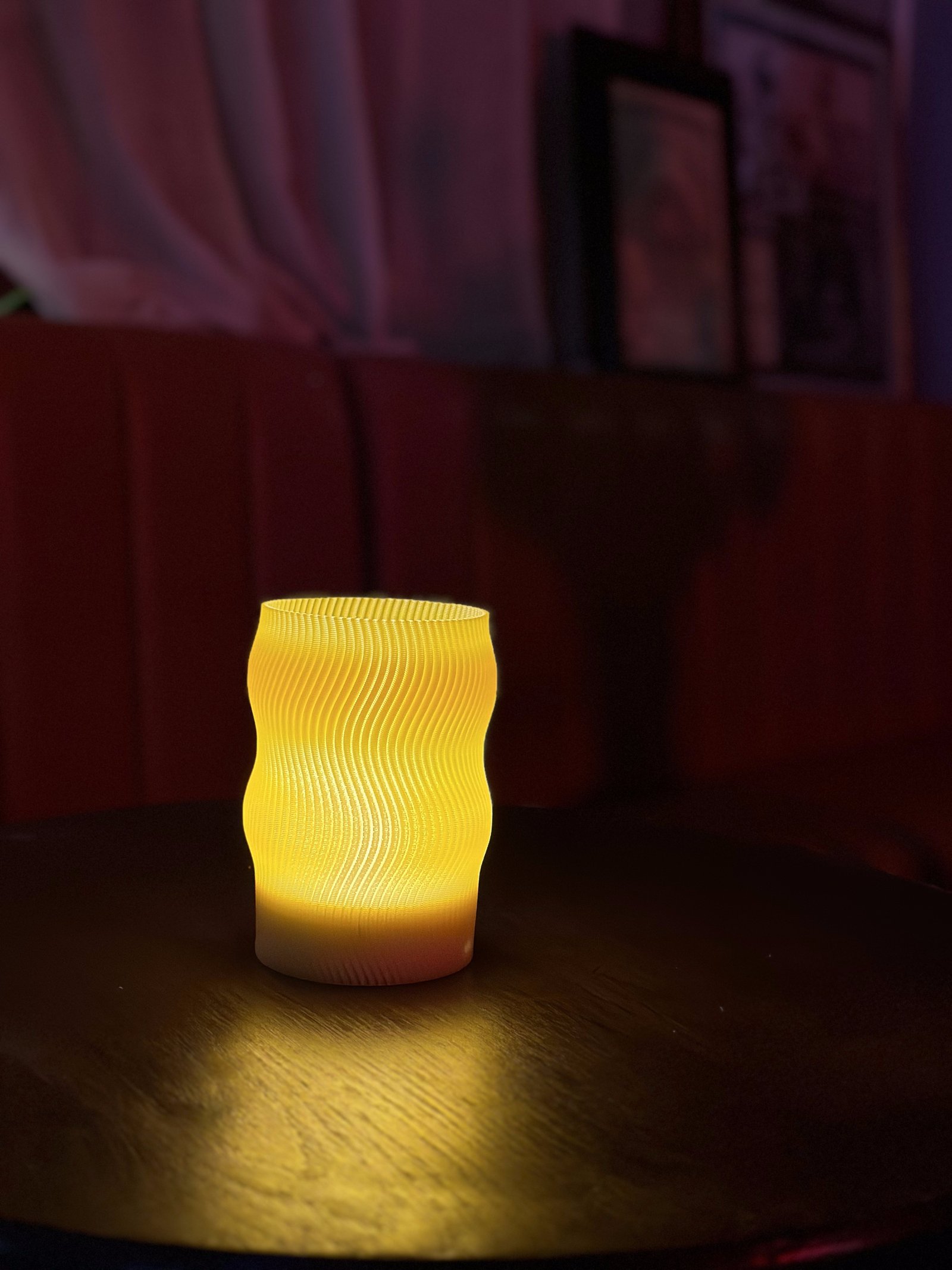 Flow lamp glowing warmly on a dark wood pub table